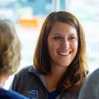 Woman smiling at Comerica Park event under tent